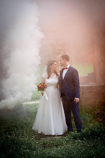 istock Young Wedding Couple Standing In Smoke Haze 2252523026