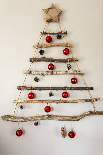 istock Handmade Rustic Christmas Tree On Wall, Raw Sticks, Red Baubles Pinecones, Minimal Home Decor 2252523307