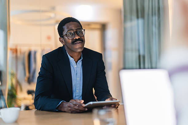 istock Serious Black Male Professional Concentrating on Tablet in Office 2252524337