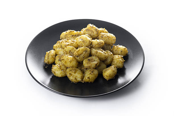 istock Gnocchi with pesto sauce served on black plate 2252526061