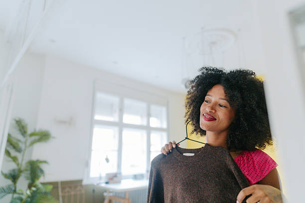 istock Young woman is getting dressed in her home 2252526137