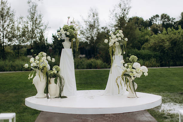 istock Outdoor wedding ceremony altar with white floral arrangements 2252528647