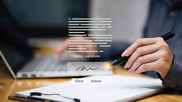 istock Digital signature on tablet with stylus beside laptop, e-sign document and approval 2252529776