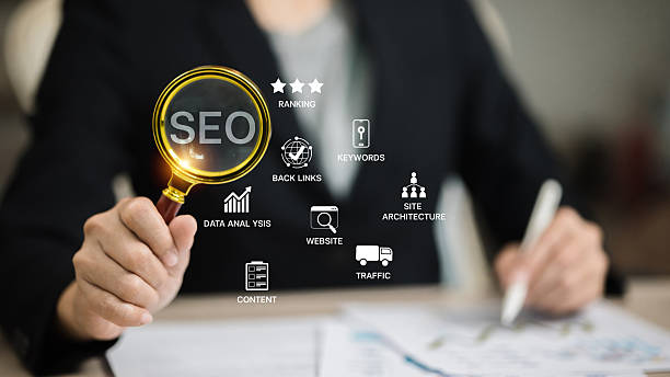 Businessman holding magnifying glass with SEO icons, illustrating search engine optimization strategy, website ranking, keywords, backlinks, and data analytics for digital marketing success.