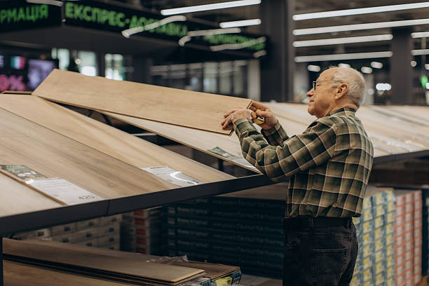 istock Senior man selecting wood laminate flooring in hardware store 2252530142