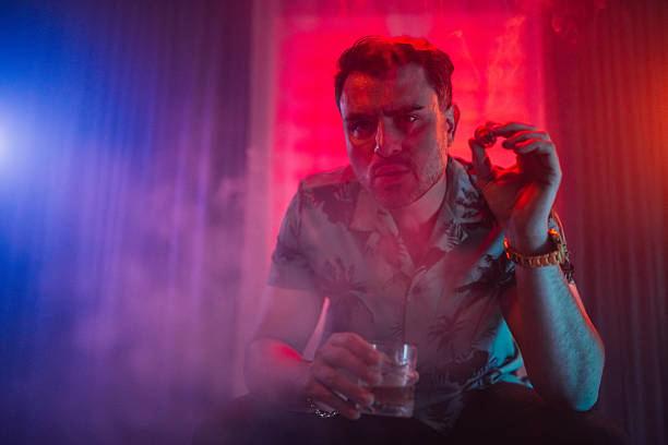 istock Mid-Adult Man Smoking A Cigar While Drinking Whiskey On The Sofa Indoors 2252531533