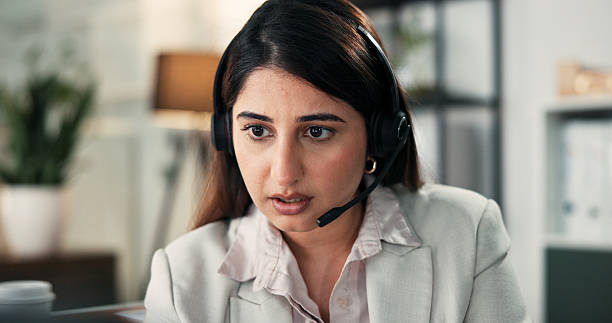 istock Woman, headset and talk with consultation at office, problem solving or contact at financial company. Person, advisor or broker with voip microphone, solution and review at asset management agency 2252534322