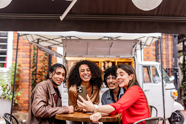 istock Friends making video call in coffee shop 2252534358
