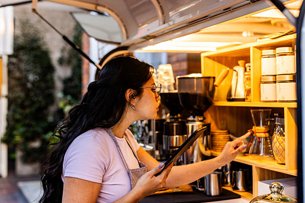 istock Employee using a digital tablet in a coffee shop 2252535516