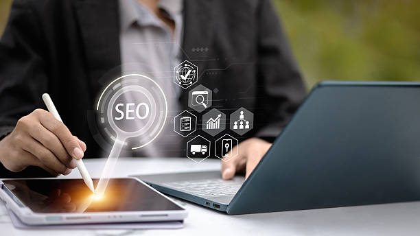 istock Business Professional Using Tablet with Stylus and Laptop Showing SEO Interface 2252535817