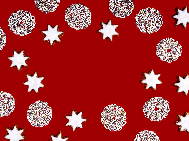 Cinnamon stars and chocolate wreaths on a red background with copyspace