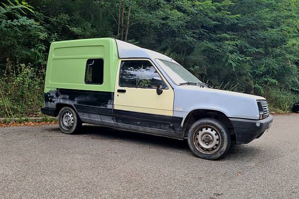 Old historical Renault Extra, Rapid, Express van in patchwork colors standing on a parking place