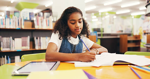 istock Writing, homework and girl in library, student and education with knowledge, learning and growth. Kid, notebook and child development with assessment, creativity and inspiration with ideas and test 2252537883