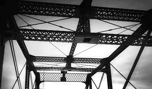 Silhouette bridge abstract geometric frames at dawn, black and white retrostyle photo with high contrast.