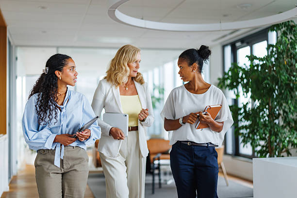 istock Collaborative Female Leaders Engaging in Office Hallway Discussion 2252538440