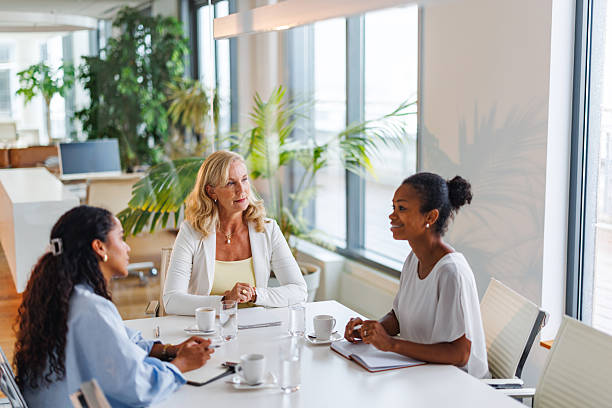 istock Businesswomen Collaborating Around Table in Bright Office Space 2252538484