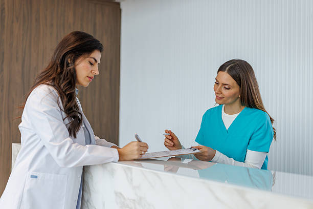 istock Medical professionals working at clinic reception desk 2252539181