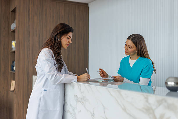 istock Doctors and nurses working in clinic reception area 2252539816