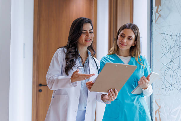 istock Medical professionals collaborating on documents in a hospital corridor 2252539838