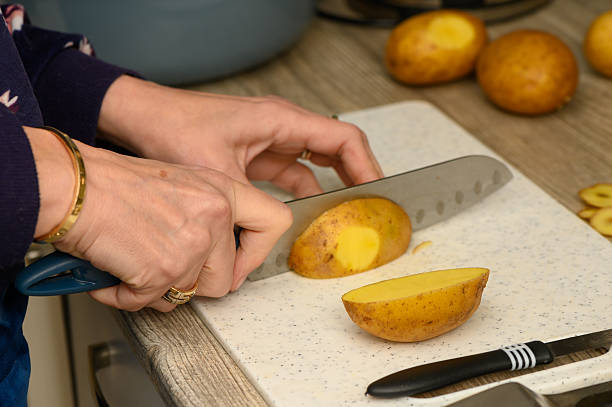 istock Preparing Potato Wedges on a White Plastic Board 2252540307