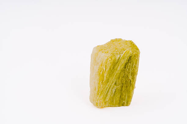 Vibrant yellow freeze-dried fruit piece isolated on a clean white background, highlighting its unique texture and natural preservation, ideal for healthy snacks, culinary creativity