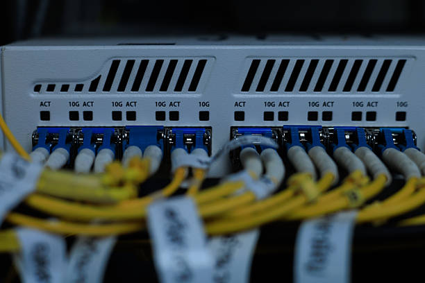 istock Yellow coiled fiber optic patch cord with blue connectors SFP modules are essential for high-speed data transmission over fiber optic networks. 2252544374