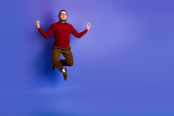 istock Young handsome student wearing sweater leaps in purple studio with blue background for fashion education lifestyle advertising 2252544382