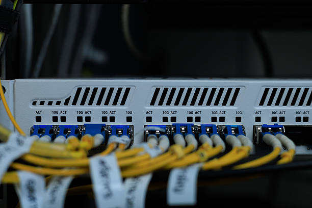 istock Yellow coiled fiber optic patch cord with blue connectors SFP modules are essential for high-speed data transmission over fiber optic networks. 2252545058