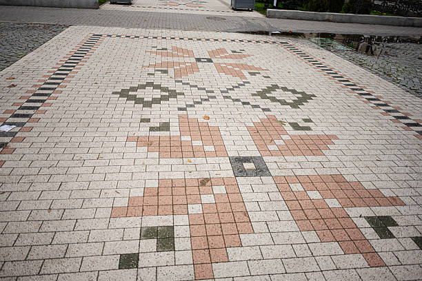 Chisinau, Moldova - November 22, 2025: Decorative tiled pavement in a public plaza in Chisinau featuring geometric and mosaic patterns in soft colors.