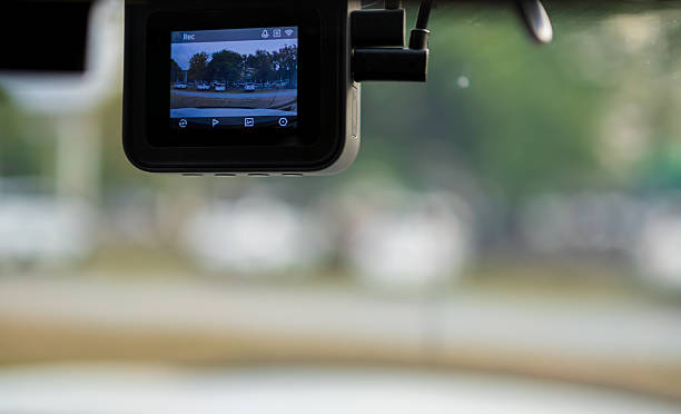 istock Car dashcam,Close-Up Of Digital Camera On Windshield In Car. Dashcam mounted in the windshield with lens flare. 2252546817