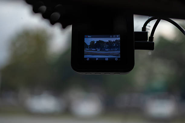 istock Car dashcam,Close-Up Of Digital Camera On Windshield In Car. Dashcam mounted in the windshield with lens flare. 2252546880