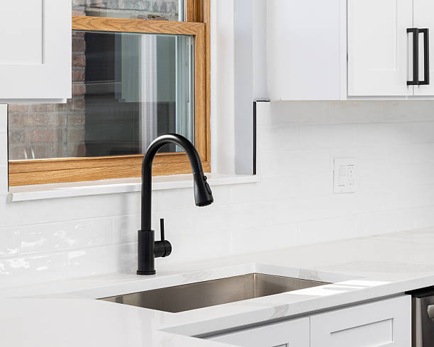 istock A black faucet detail in a white kitchen. 2252549940