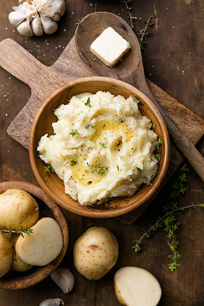 istock Mushed potatoes top view with raw potatoes and spices 2252552328