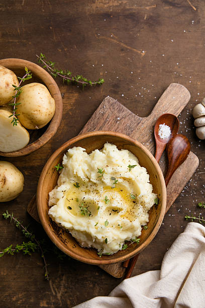 istock Mushed potatoes top view with raw potatoes and spices 2252552334
