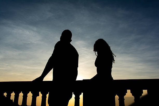 Salvador, Bahia, Brazil - December 12, 2025: The silhouette of two people is seen walking during sunset at Barra beach in Salvador, Bahia.