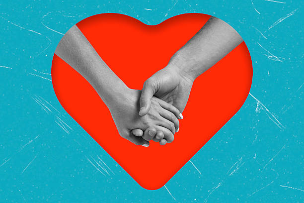 istock Hands holding together inside a heart shape on a blue background showing love and connection between two people 2252555094