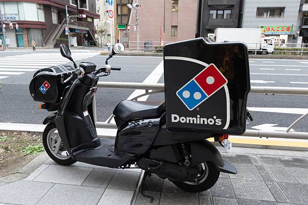 Tokyo, Japan - November 27, 2025 : Domino's Pizza delivery scooter in Tokyo, Japan.