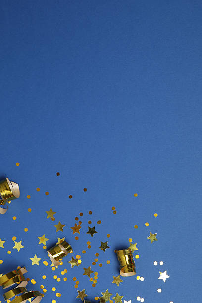istock Golden confetti on blue background, top view 2252555744