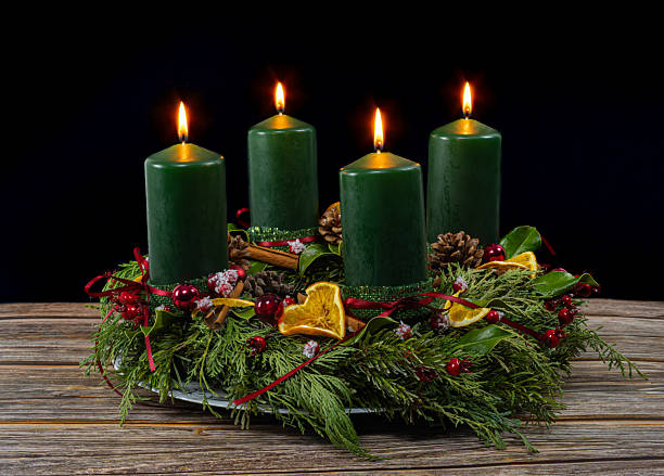 istock Decorated Advent wreath with four green burning candles 2252557492