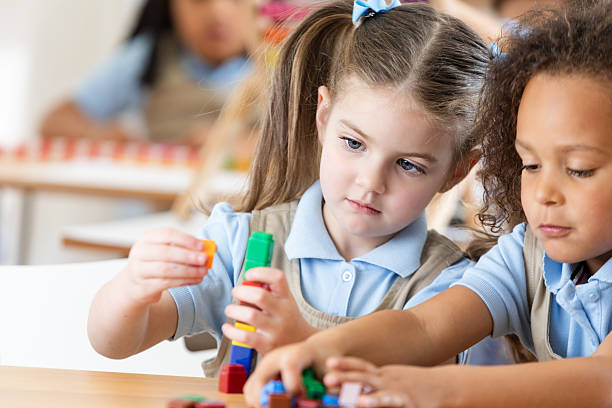 istock Children in classroom engaged in educational activity with colorful building blocks 2252558383