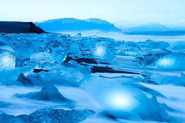 Big Chuck of Ice on Volcano sand beach in Iceland. Ice breaks off from the Iceberg in Iceland.