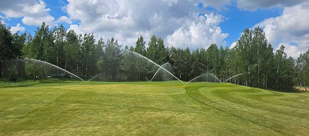istock Sprinkler system for watering a golf course on a sunny day 2252562202