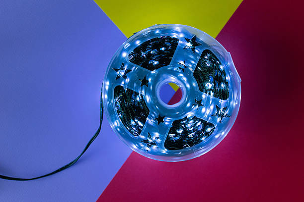 istock Glowing Blue LED String Lights on Colorful Geometric Background 2252562622