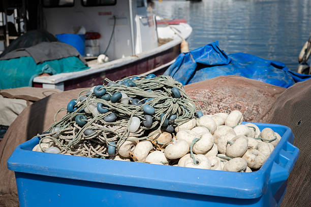 Industrial Fishing boat moored at the harbor with large fishing nets drying out