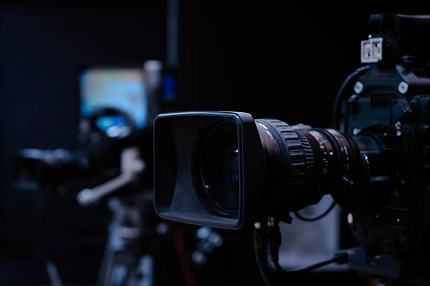 istock Professional broadcasting cinema camera lens capturing news and television content in a modern studio setting, preparing for a live stream or film production 2252564621