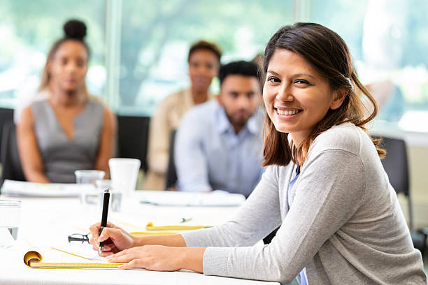istock Diverse group of professionals collaborating and learning in a bright, modern meeting room. 2252568264