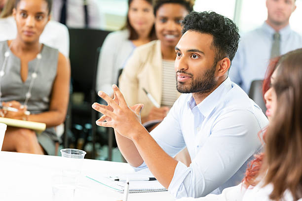 istock Diverse group of professionals in a collaborative indoor meeting, discussing ideas and working together. 2252568311