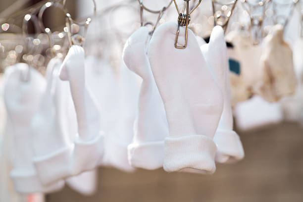 Clean baby clothes hanging on a clothesline with natural light