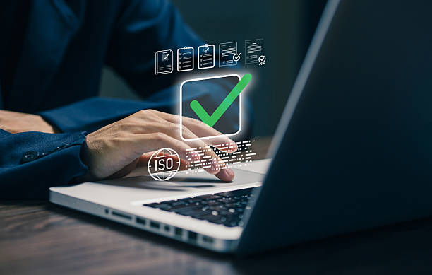 istock A business professional uses a laptop with ISO certification and approval icons, representing quality management systems, compliance standards, audit processes, risk control. 2252573910