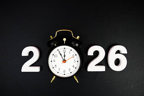 istock Happy New Year 2026 and alarm clock on black background 2252579713